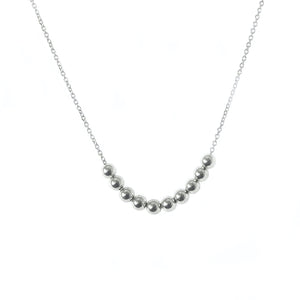 A  delicate necklace with sterling silver balls