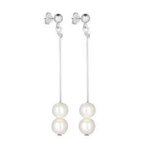 Stunning long dangle earrings, featuring two freshwater pearls that are suspended from a silver ball.