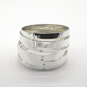 a stack of solid sterling silver bangles