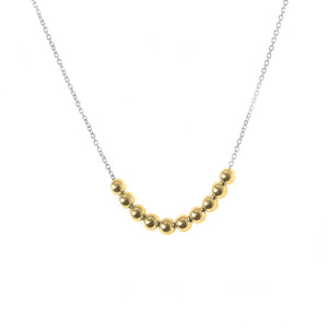 An everyday gold dainty necklace featuring 10 small 9k gold balls on a delicate sterling silver chain. 