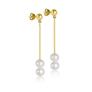 Stylish double pearl drop earrings featuring two white pearls dangling from a slim gold rod, secured by a stud backing. Ideal for adding a touch of elegance and luxury to any ensemble.