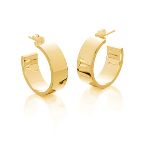 large gold hoop earrings with a high polished finish on a white background