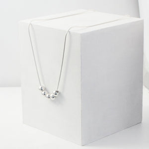 a contemporary ball and chain necklace 