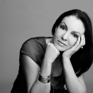 Portrait of Sophie Hillsdon, the talented designer behind the SOPHIE ANNA brand, elegantly wearing a set of sterling silver stack bangles, showcasing her own signature design.