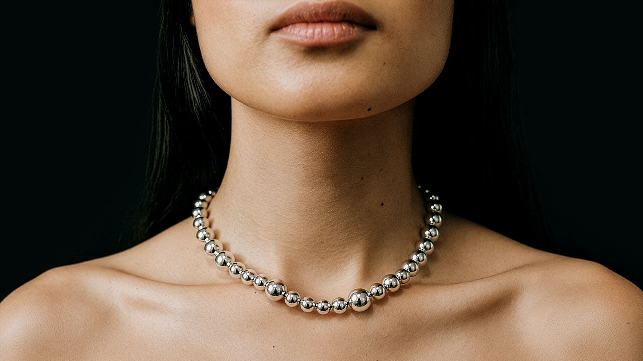 Model wearing a sterling silver graduated ball bead necklace by SOPHIE ANNA