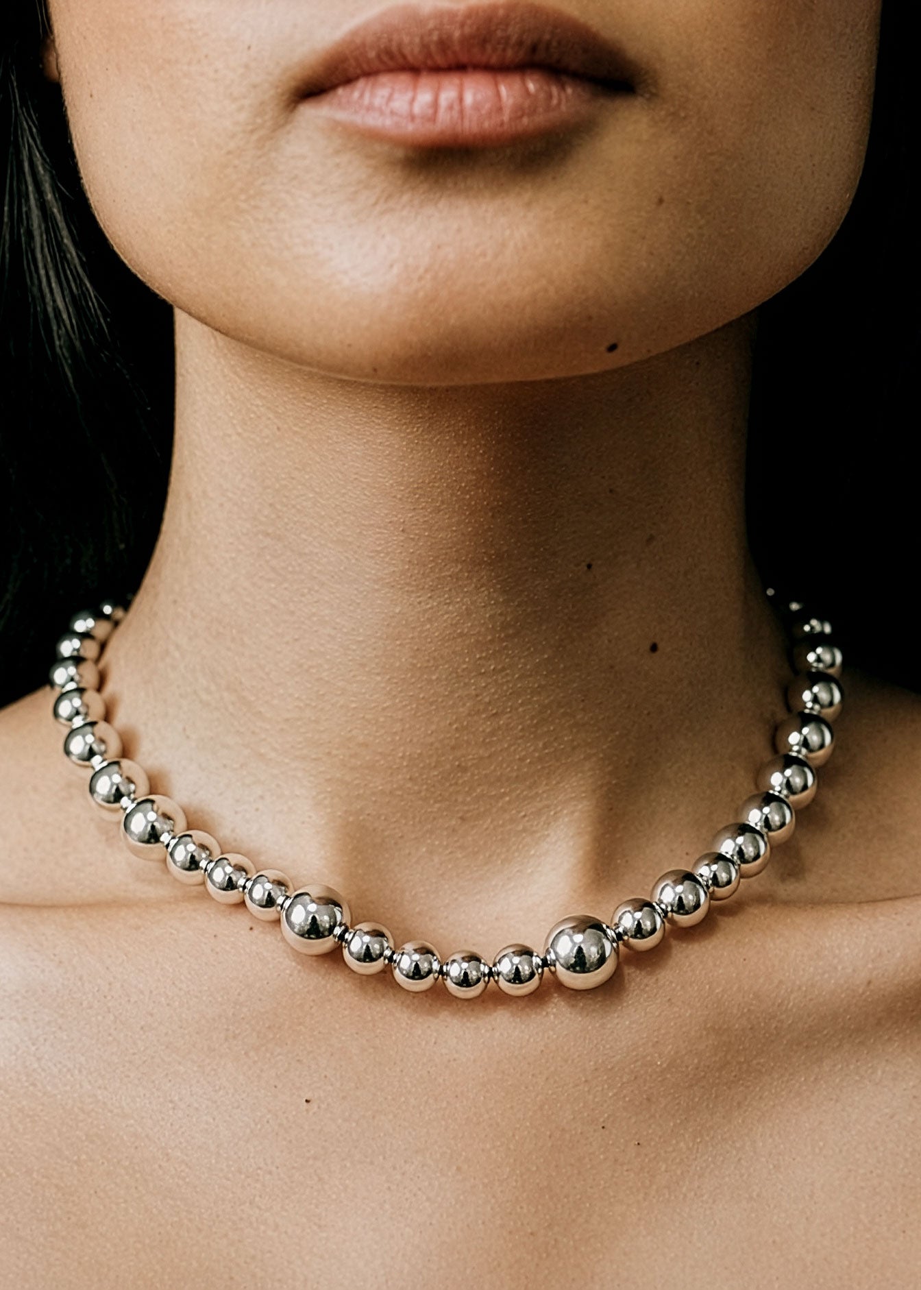 Model wearing a sterling silver graduated ball bead necklace by SOPHIE ANNA