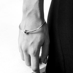 Solid sterling silver ball bangle on model