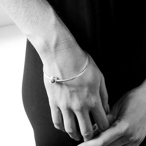 Solid sterling silver ball bangle on model