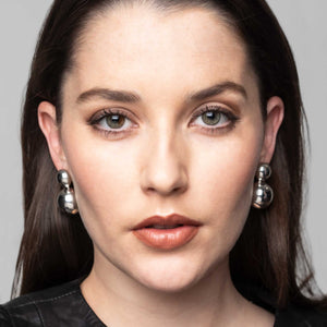 high polished sterling silver double ball earrings on a model