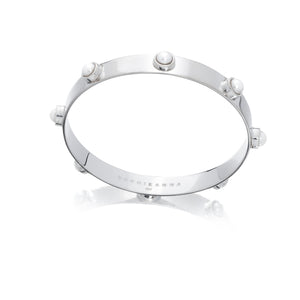 a flat 9mm wide sterling silver bangle with freshwater pearls set 20mm apart